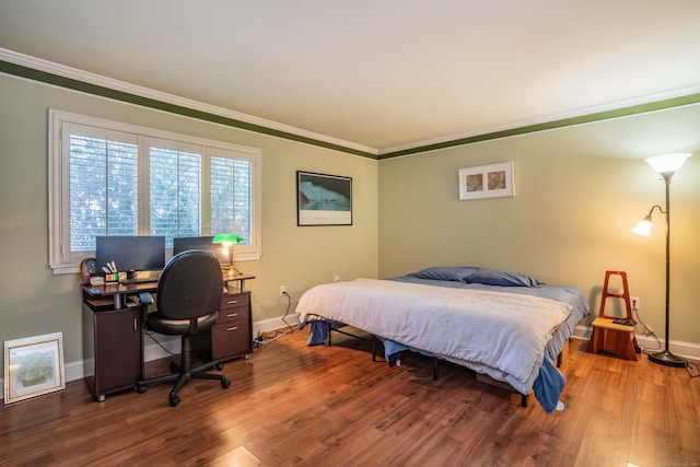 bedroom featuring hardwood / wood-style floors and ornamental molding