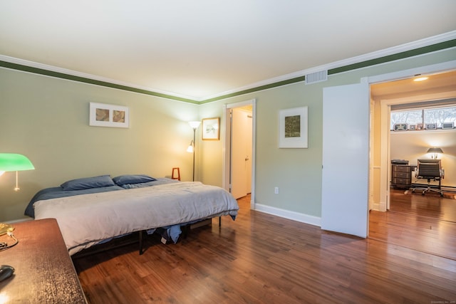 bedroom featuring dark wood-type flooring and ornamental molding