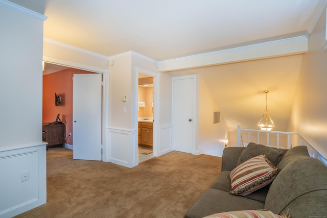 carpeted living room featuring ornamental molding and a chandelier