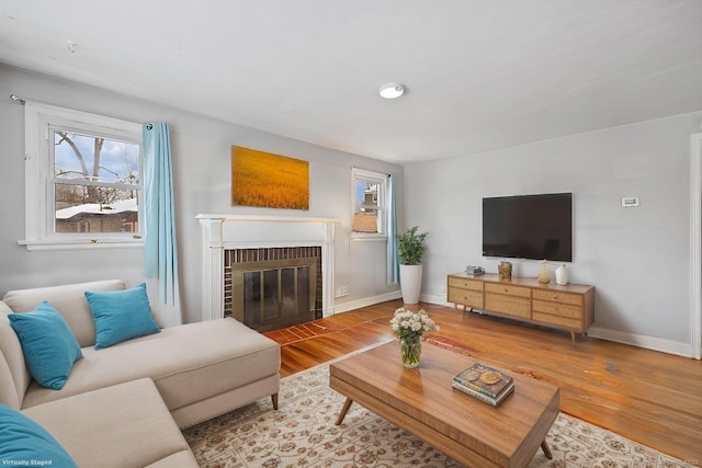 living room featuring wood-type flooring and a fireplace