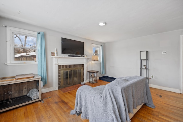 living room featuring a brick fireplace and light hardwood / wood-style floors