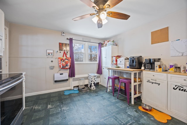 interior space featuring ceiling fan and heating unit