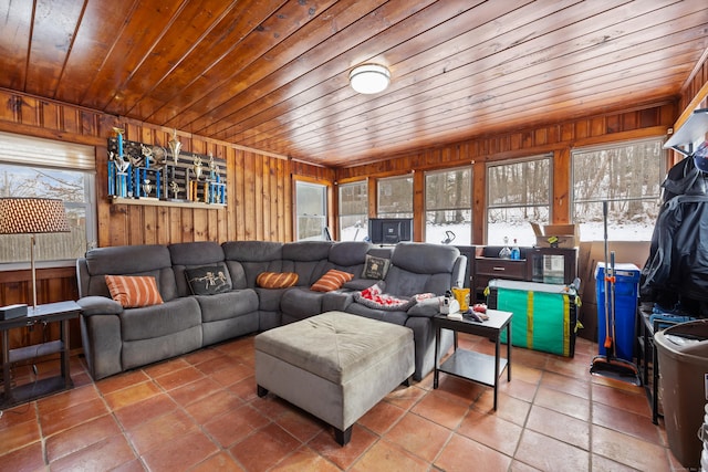 tiled living room featuring wood ceiling, a healthy amount of sunlight, and wood walls