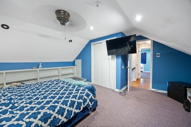 bedroom featuring ceiling fan, vaulted ceiling, and carpet