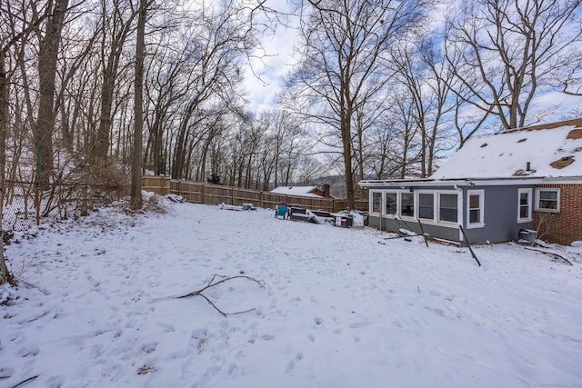 view of yard layered in snow