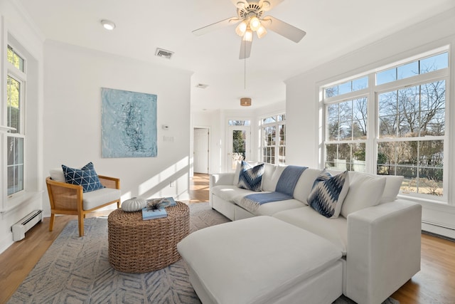 living room featuring a baseboard radiator, wood-type flooring, and ceiling fan