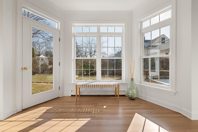 unfurnished sunroom with a baseboard heating unit