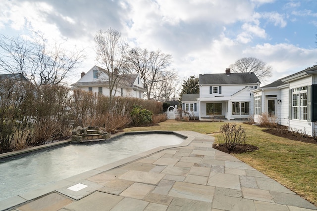 view of pool featuring a patio and a lawn