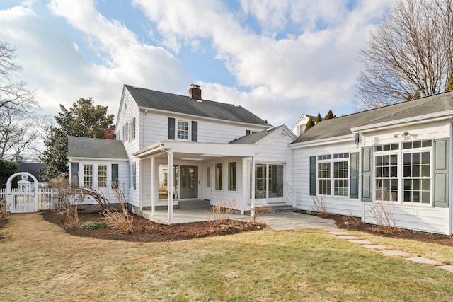 rear view of house featuring a yard and a patio area