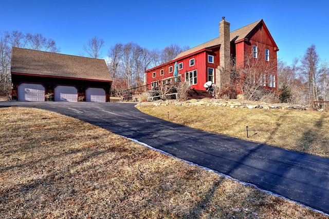 view of property exterior featuring a garage and a yard