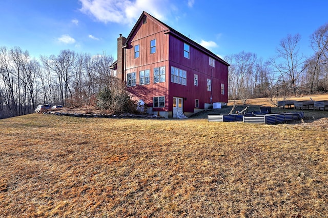 view of side of home with a yard