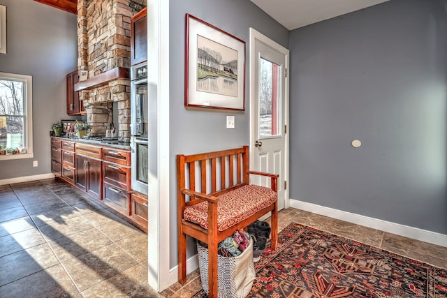 hall with tile patterned floors