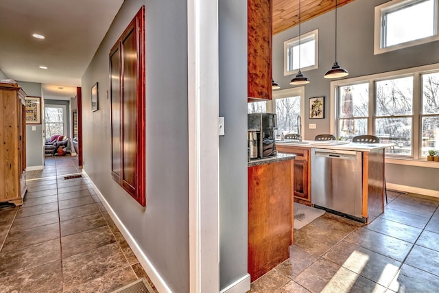 kitchen with sink, decorative light fixtures, and stainless steel dishwasher