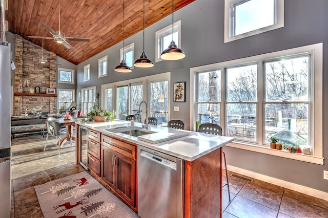 kitchen with stainless steel dishwasher, pendant lighting, sink, wooden ceiling, and a center island with sink