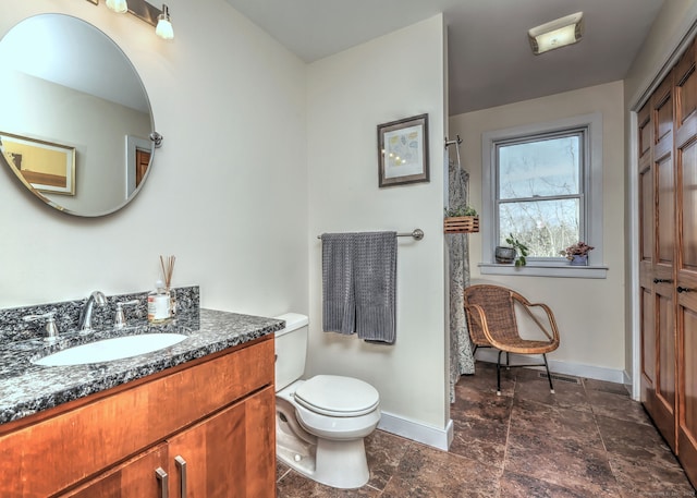 bathroom with toilet and vanity