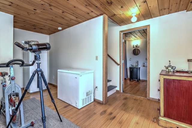 interior space with wooden ceiling, lofted ceiling, and light wood-type flooring