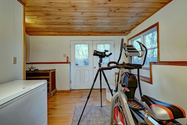 exercise area with wooden ceiling, light hardwood / wood-style floors, and lofted ceiling