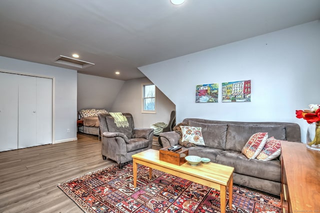 living room with hardwood / wood-style floors and lofted ceiling