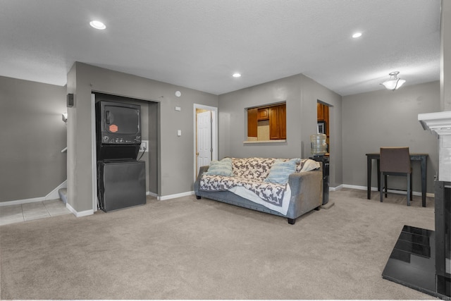 carpeted living room with a tile fireplace and a textured ceiling