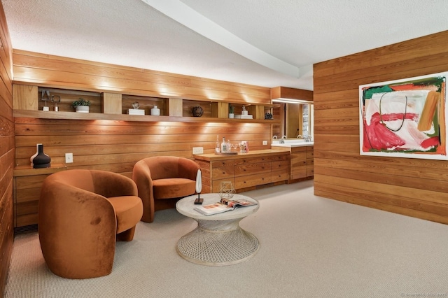 living area with carpet floors, wooden walls, and lofted ceiling