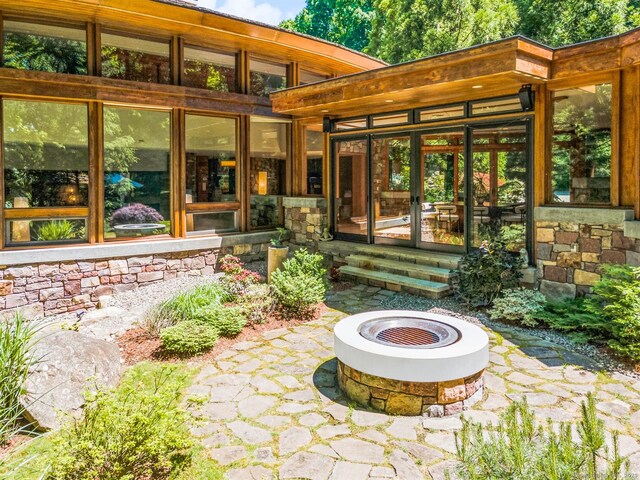 22 Father Peters Ln, New Canaan, CT 06840 - view of patio / terrace featuring an outdoor fire pit and french doors