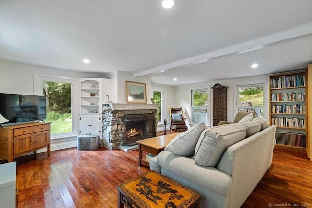 living room featuring dark wood-type flooring, recessed lighting, a fireplace, and beamed ceiling