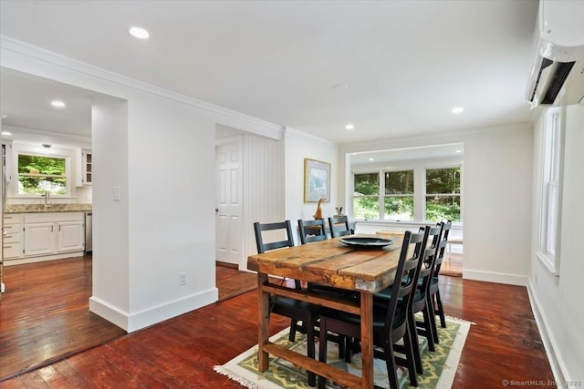 dining space featuring dark wood-style floors, baseboards, and crown molding