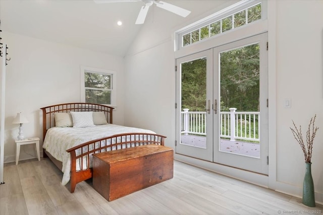 bedroom with lofted ceiling, light wood-style floors, access to outside, and french doors