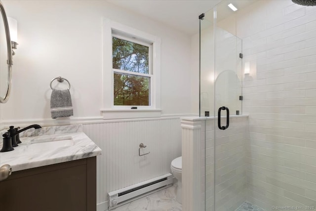 bathroom featuring toilet, a wainscoted wall, marble finish floor, baseboard heating, and a shower stall