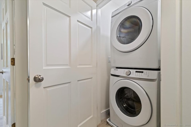 laundry room featuring stacked washer / drying machine and laundry area