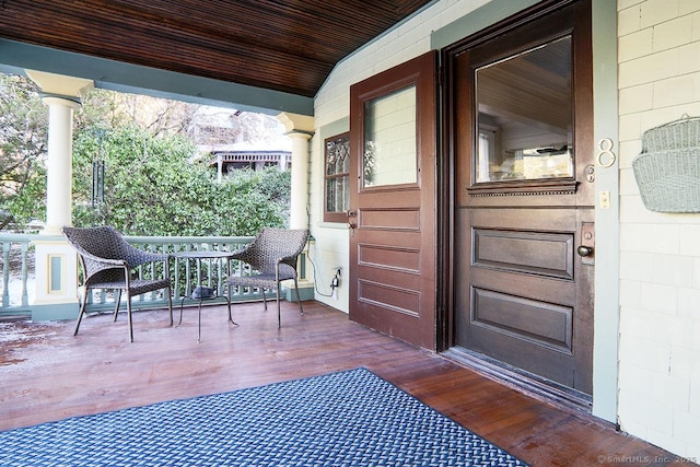 wooden terrace featuring covered porch