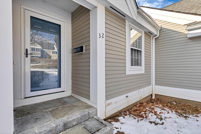 view of snow covered property entrance