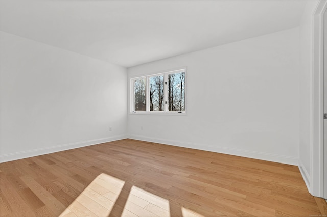 empty room with light hardwood / wood-style flooring