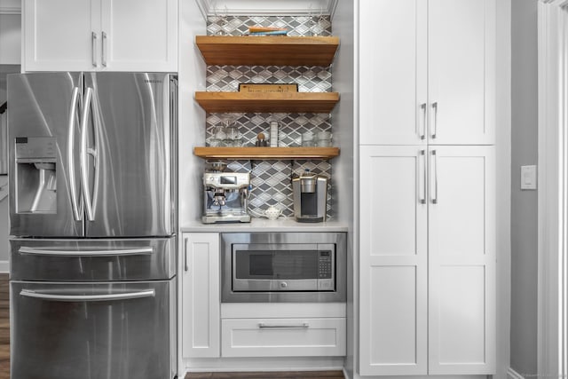 kitchen featuring tasteful backsplash, white cabinetry, appliances with stainless steel finishes, and open shelves