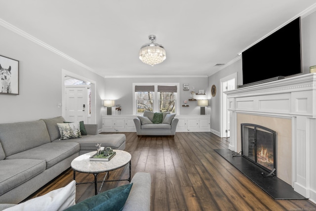 living area with dark wood-type flooring, a high end fireplace, visible vents, and ornamental molding