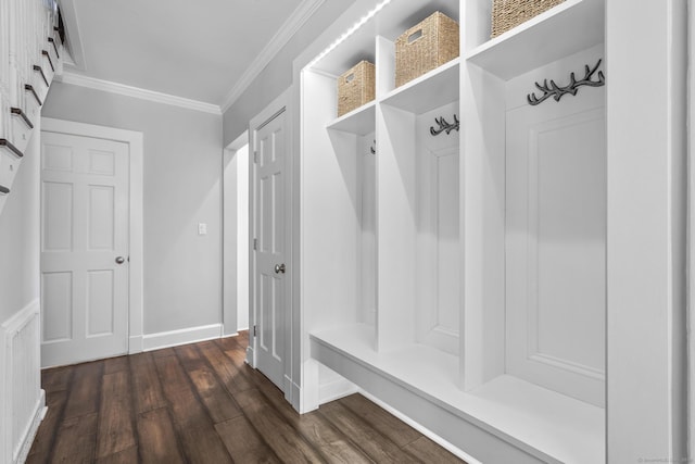 mudroom featuring ornamental molding, dark wood finished floors, and baseboards