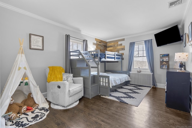 bedroom featuring multiple windows, visible vents, and dark wood finished floors