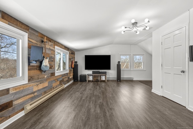 unfurnished living room with dark wood-type flooring, wood walls, and baseboard heating