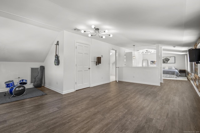 unfurnished living room featuring dark wood-style floors, lofted ceiling, visible vents, and baseboards