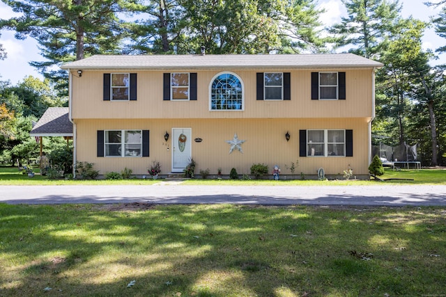 view of front facade featuring a front yard and a trampoline