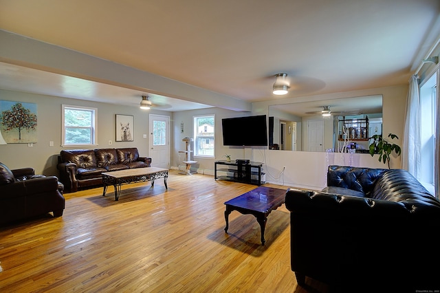 living room featuring light hardwood / wood-style floors and ceiling fan