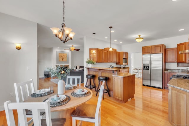 dining area with ceiling fan and light hardwood / wood-style flooring