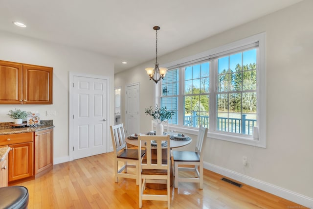 dining room featuring light hardwood / wood-style flooring and a chandelier