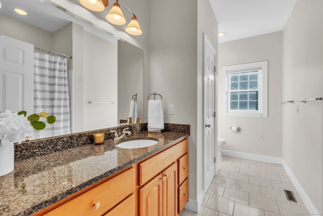 bathroom with tile patterned floors, vanity, and toilet