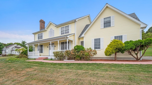 view of front of home with a front yard and covered porch