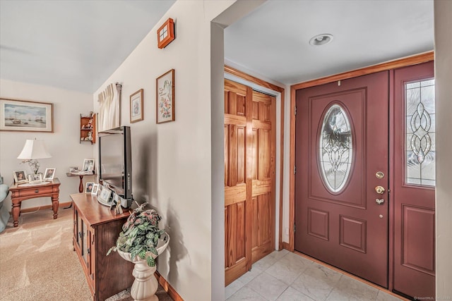 entryway with light colored carpet