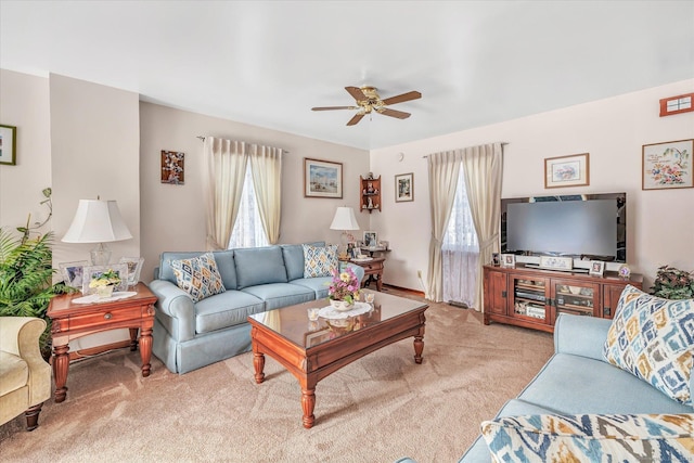 living room featuring light carpet and ceiling fan