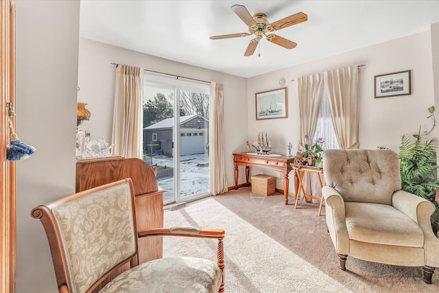 sitting room featuring ceiling fan and carpet flooring