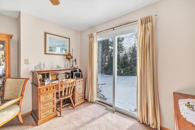 carpeted home office with ceiling fan