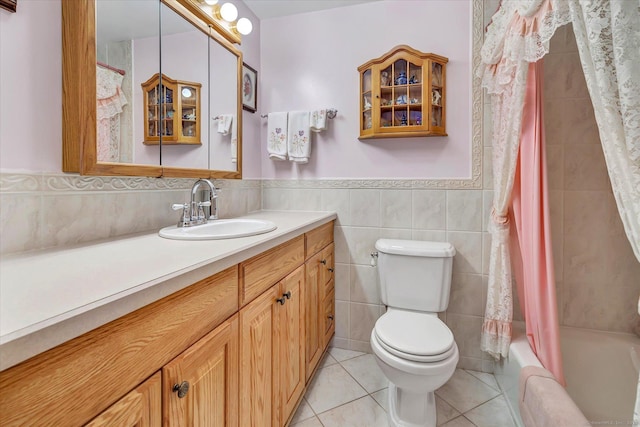 full bathroom with toilet, tile walls, vanity, shower / bath combo, and tile patterned flooring